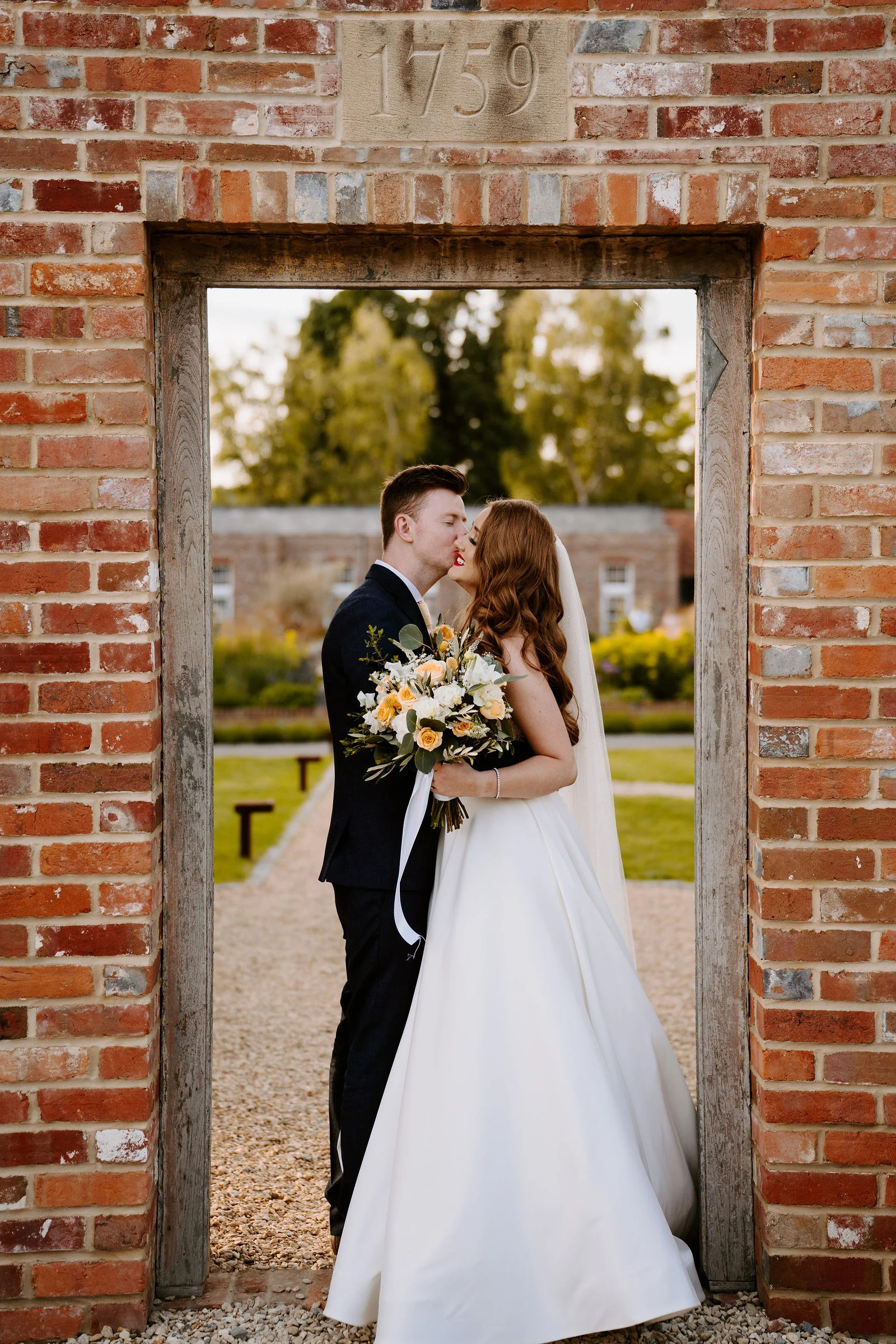 Danielle and Alex together in a brick doorway at Wasing Park