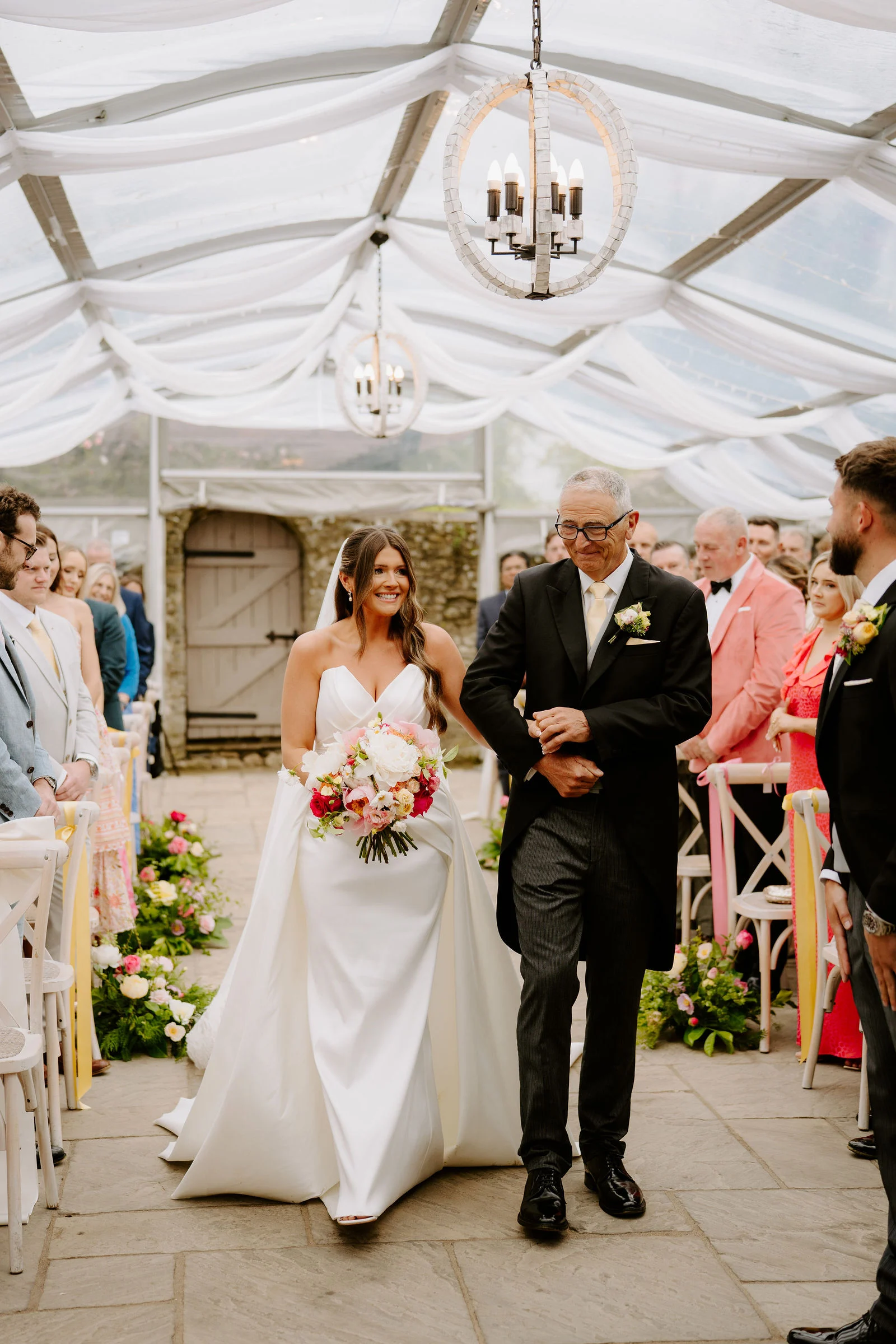Bride and groom sharing laughter during drinks reception on the manor lawns