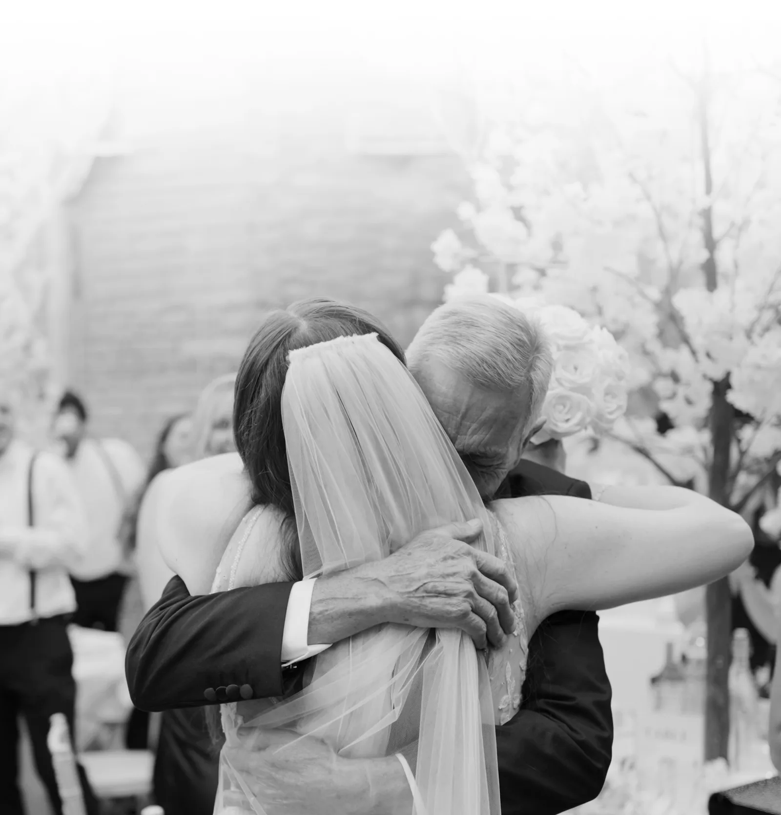 A bride embracing a family member during a wedding celebration