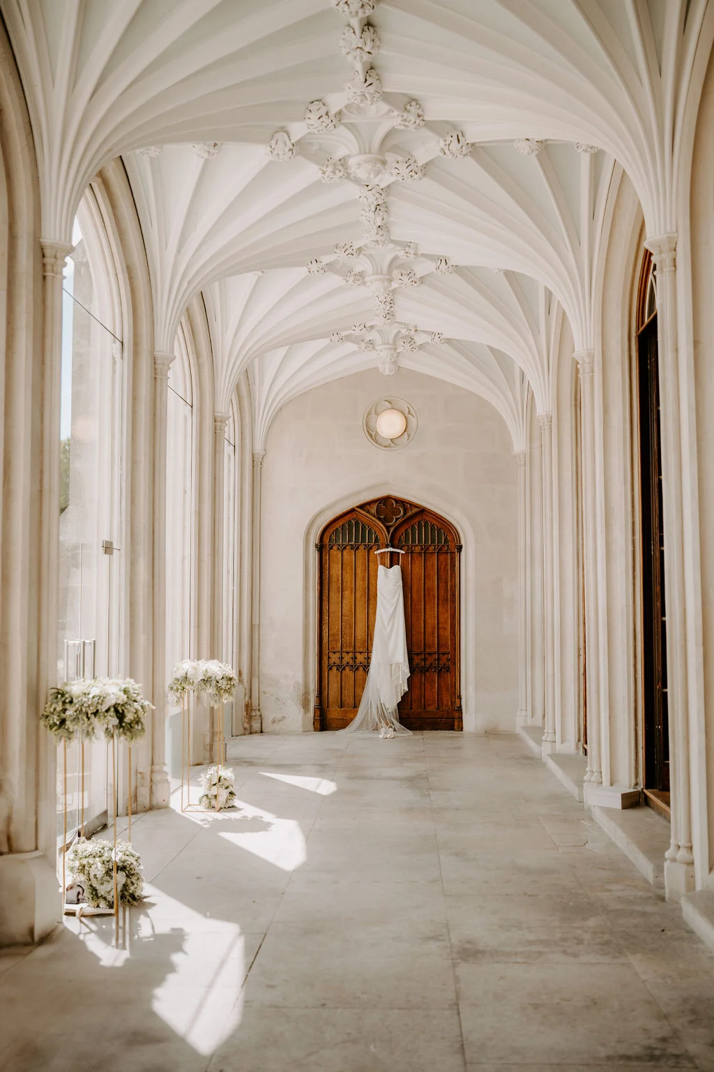 A bright vaulted corridor decorated with flowers at Ashridge House