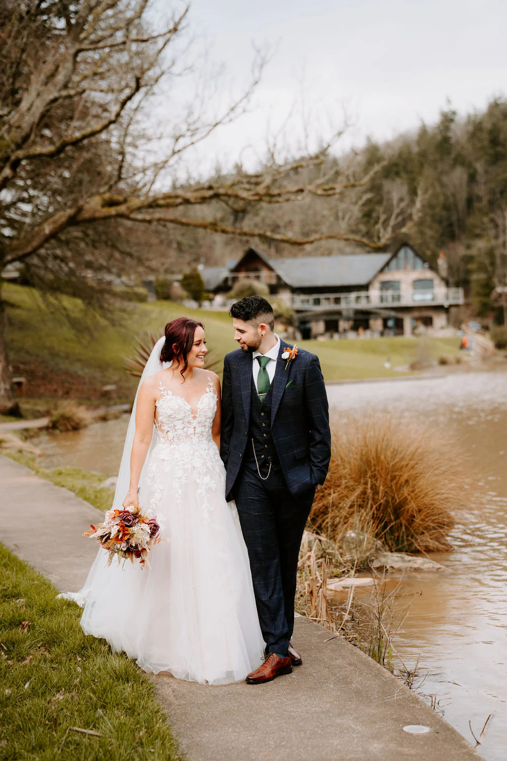 Danielle and Harry romantic wedding portrait beside the lake at Canada Lodge in Creigiau