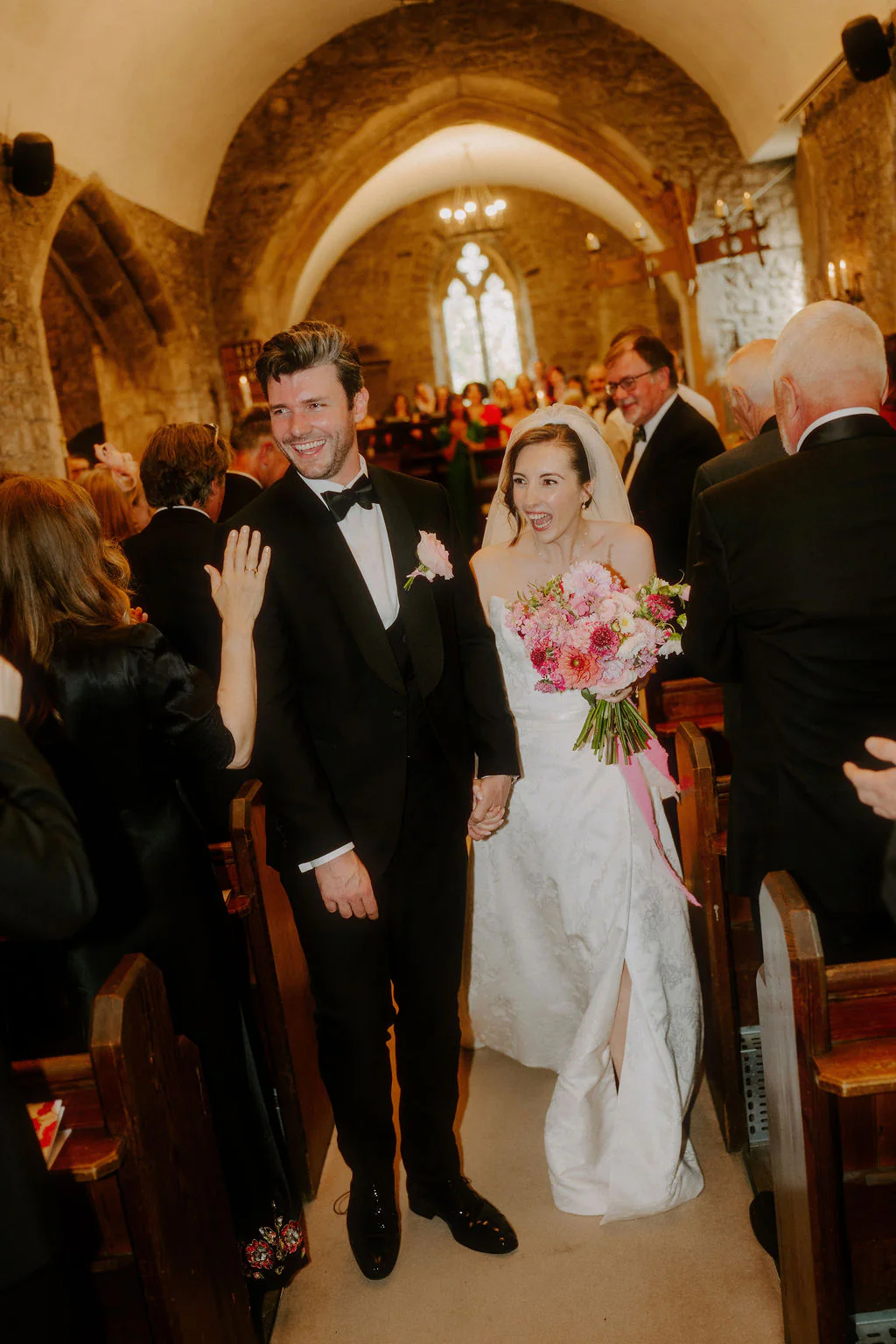 Louisa walking down the aisle during her ceremony at New House Country Hotel in Thornhill, Cardiff