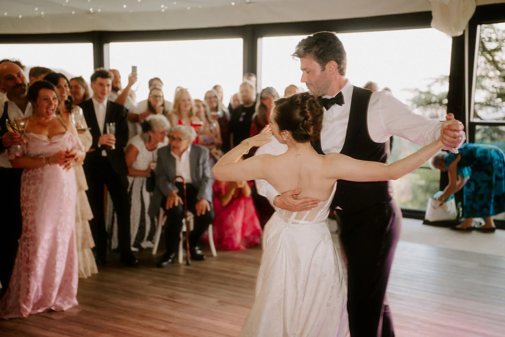 Evening Party & Dancefloor Energy | New House Country Hotel Crowded dancefloor with wedding guests dancing and singing together at New House Country Hotel in Cardiff