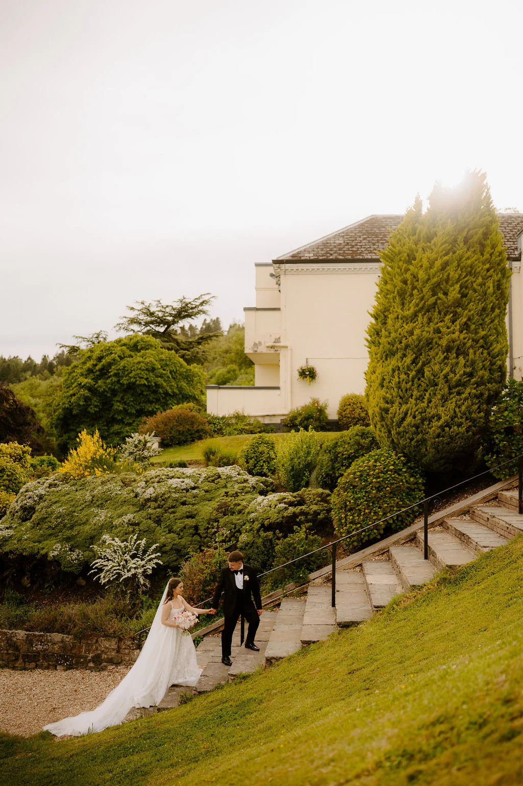 Sarah & Luke | Relaxed Garden Walk Newlyweds smiling as they walk across the private garden lawns at New House Country Hotel