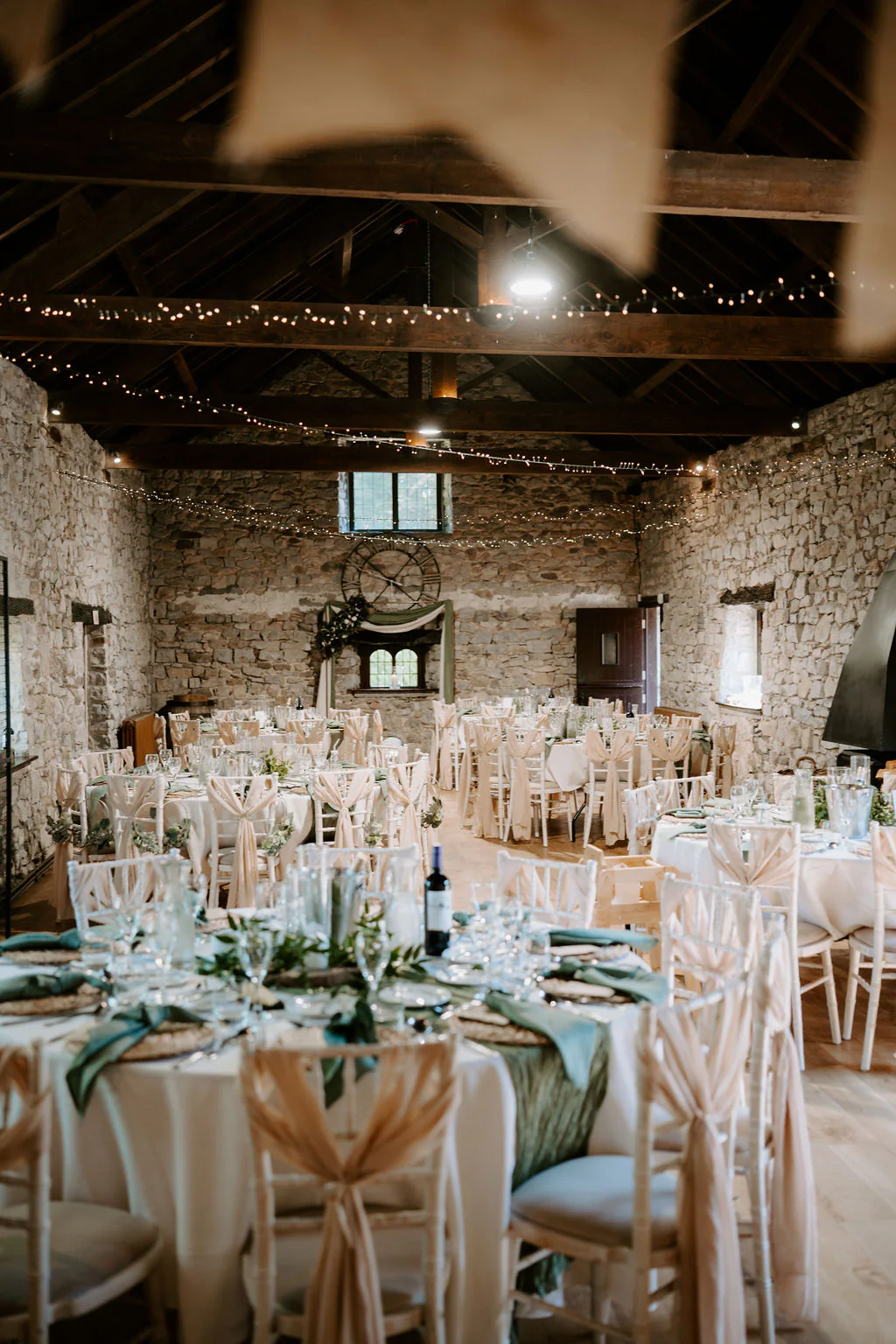 Amy and Dan laughing during speeches inside the marquee at Pencoed House Estate