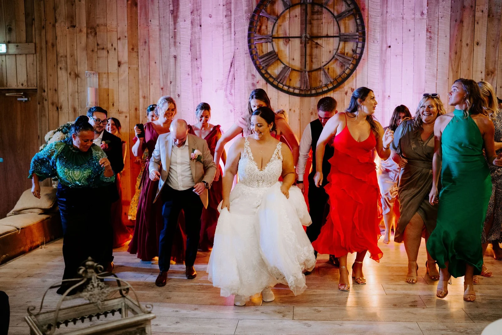 Lauren celebrating on the barn dance floor with her guests at Alcumlow Wedding Barn