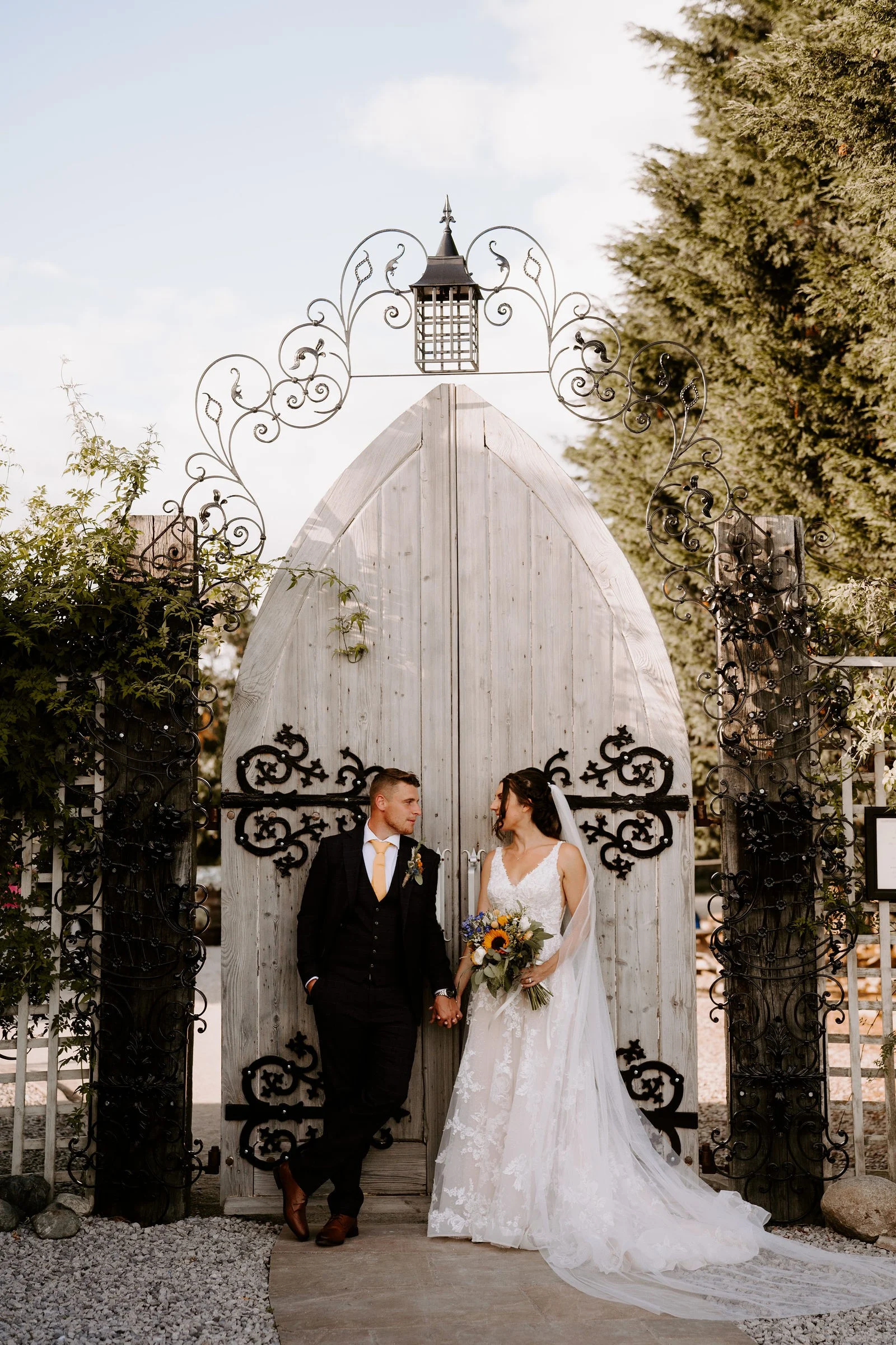 Martha and Harry standing together outside the White House at Alcumlow Wedding Barn
