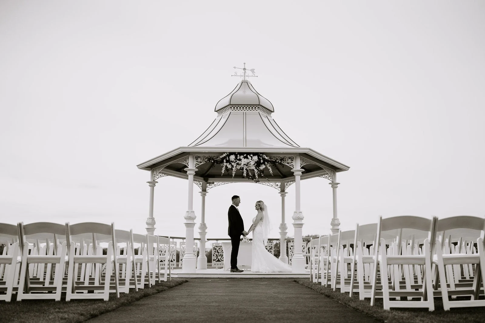 Emma and James together beneath the gazebo after their ceremony at Carden Park Hotel