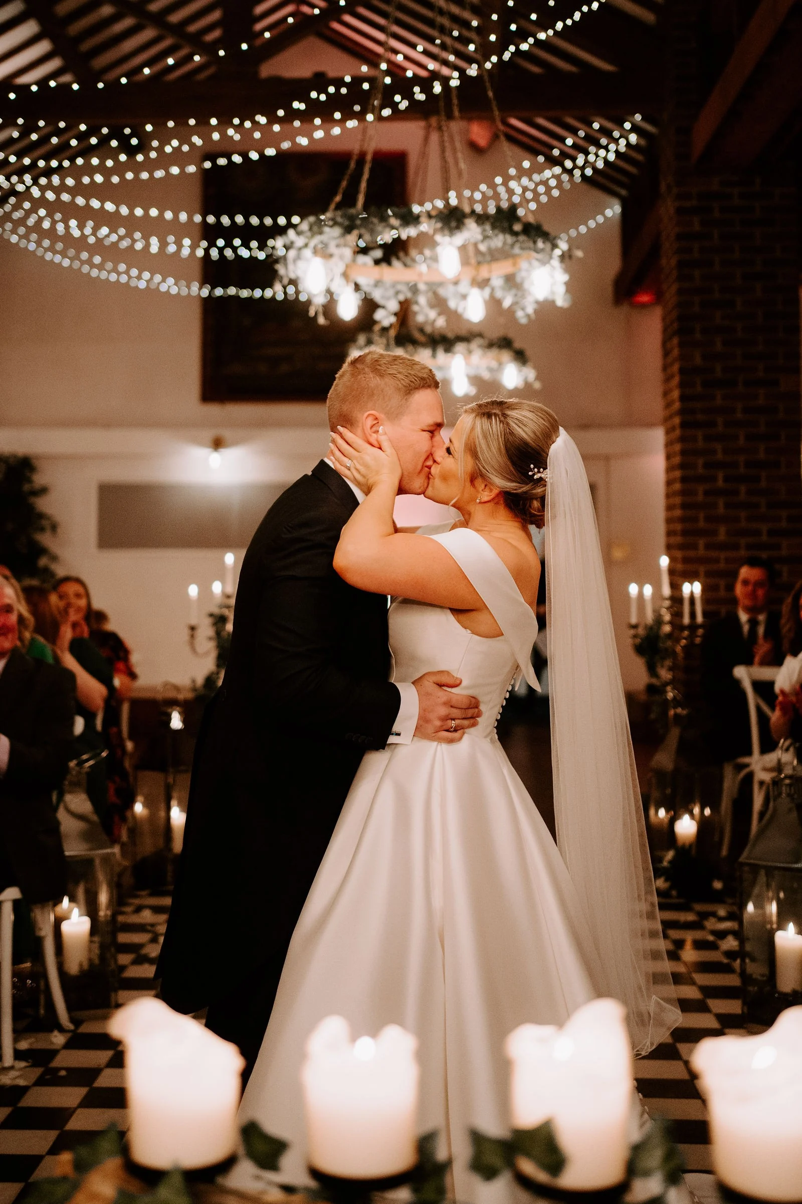 Melissa and Oliver sharing their first dance beneath the lights at Larkspur Lodge
