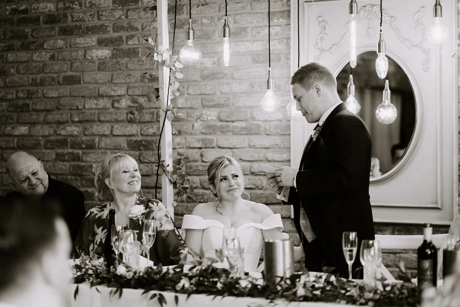 Oliver giving his speech with Melissa seated beside him at Larkspur Lodge