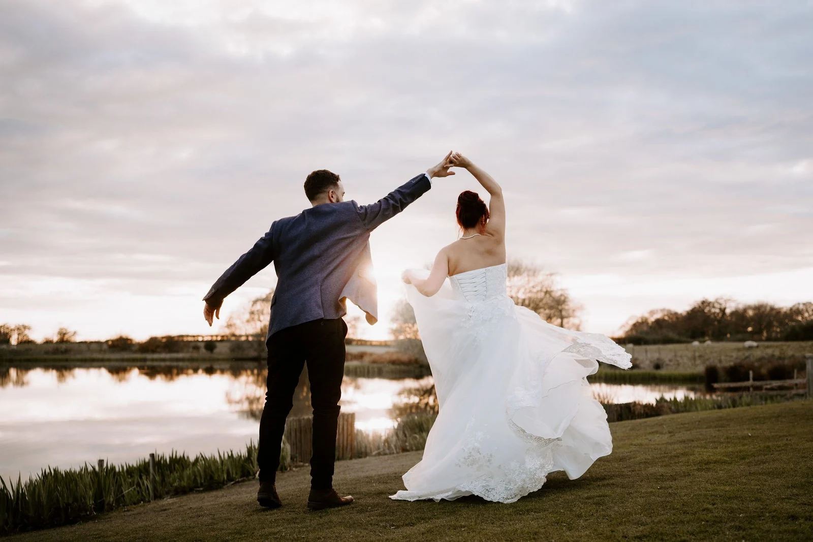 Andy and Paula twirling together beside the lake at Sandhole Oak Barn