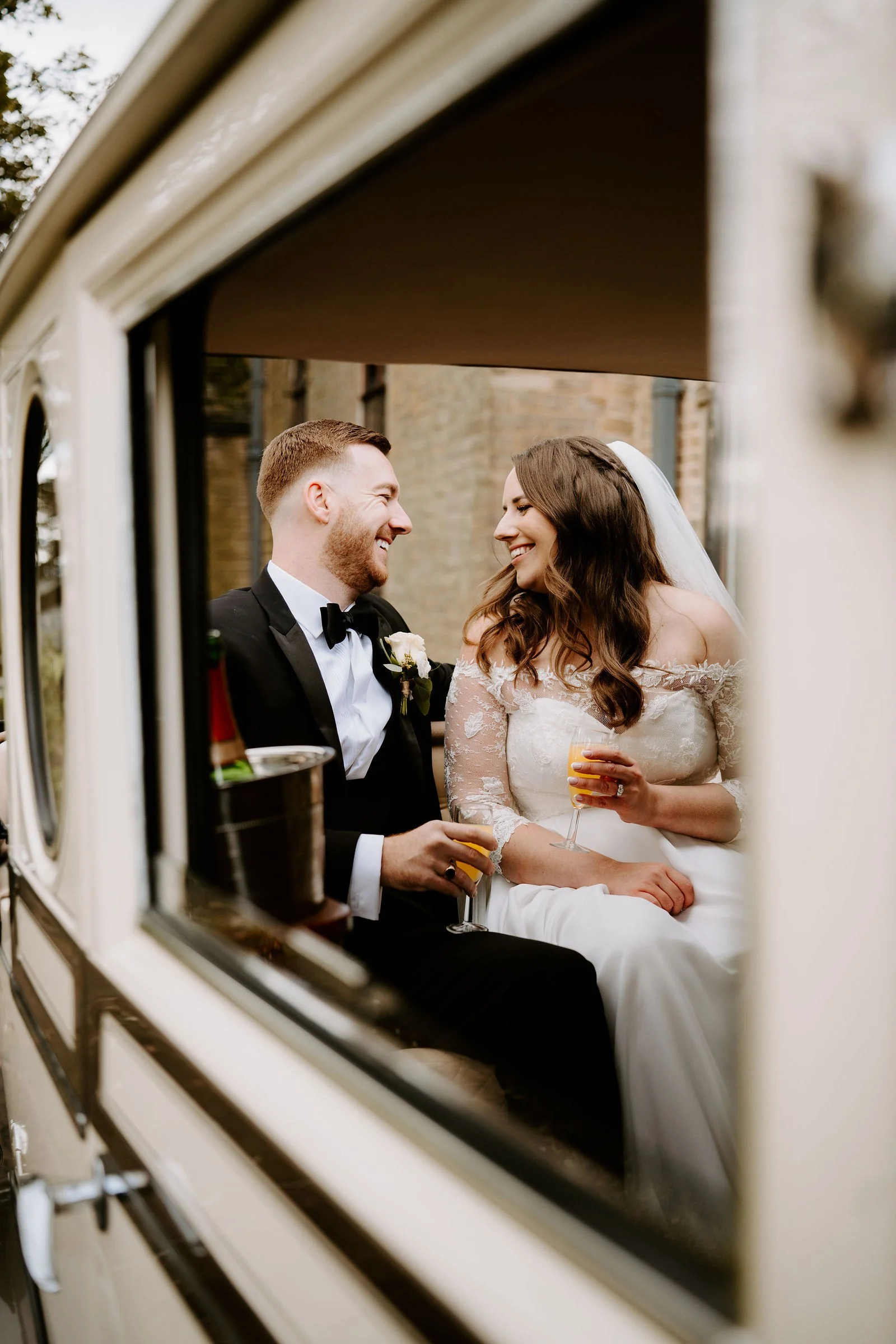 Amy and James smiling together at a window at Shrigley Hall Hotel & Spa