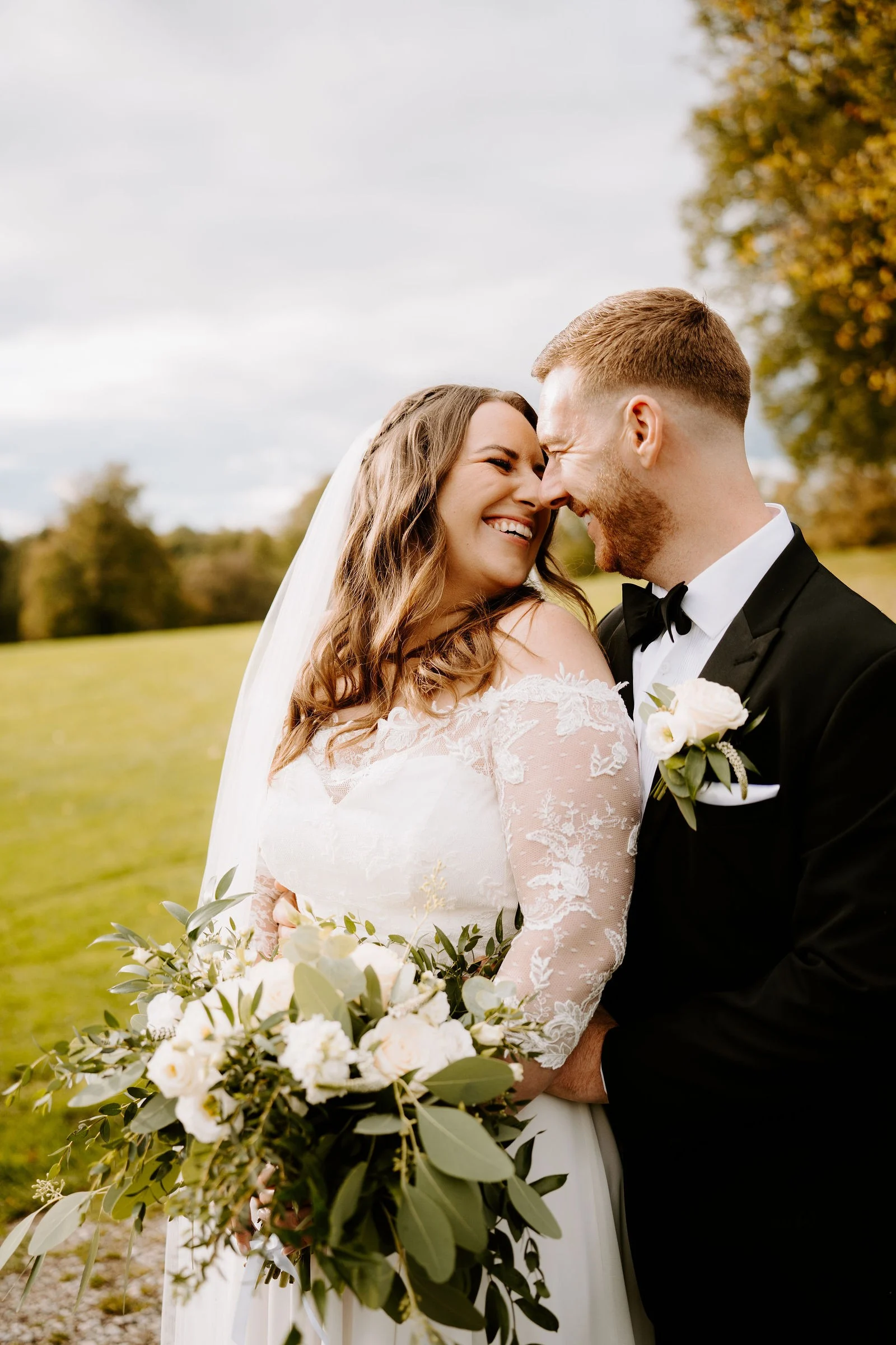 Amy and James laughing together in the grounds at Shrigley Hall Hotel & Spa