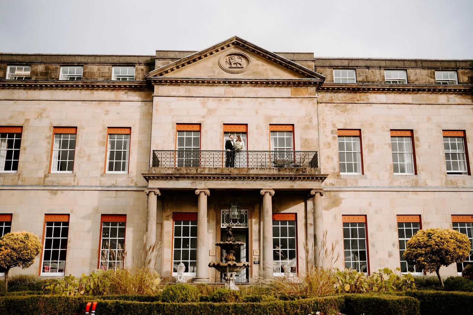 Amy and James on the balcony above Shrigley Hall’s entrance at Shrigley Hall Hotel & Spa