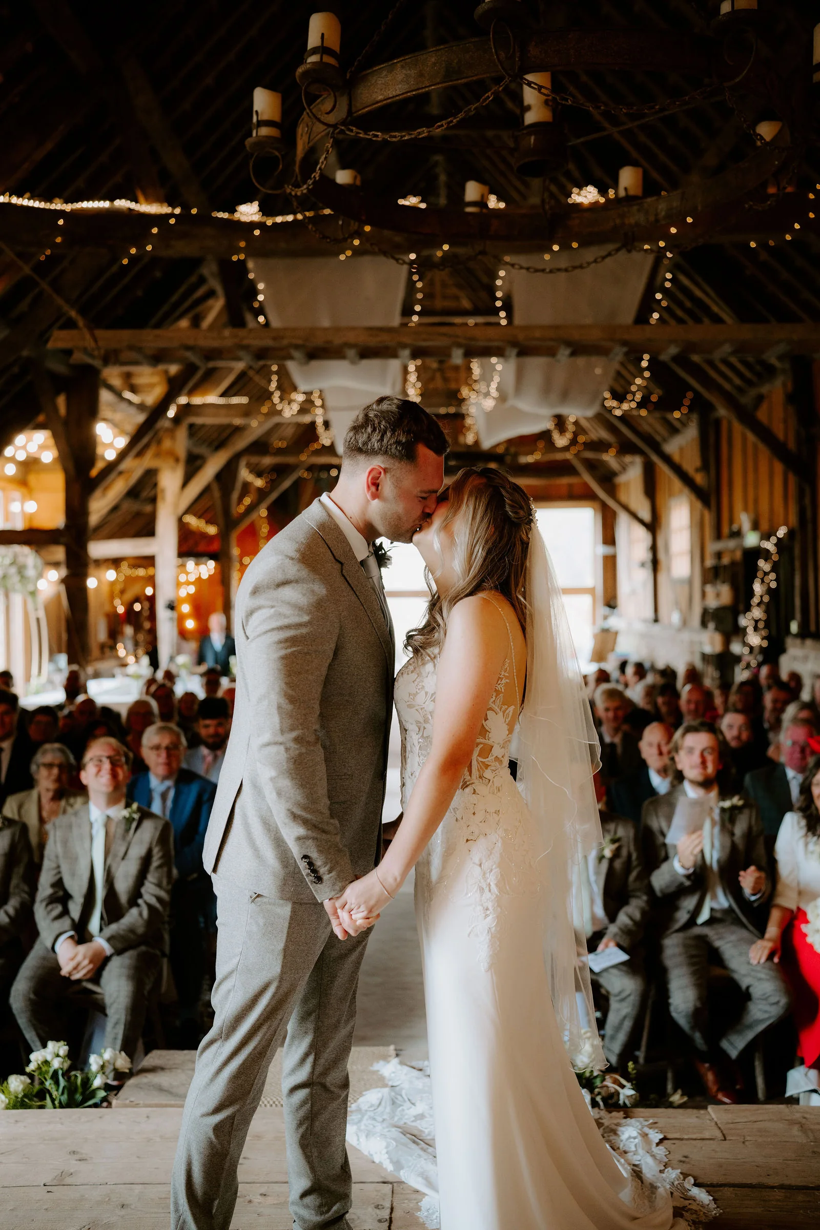 Edward and Amy's first kiss as guests applaud inside Bowerchalke Barn