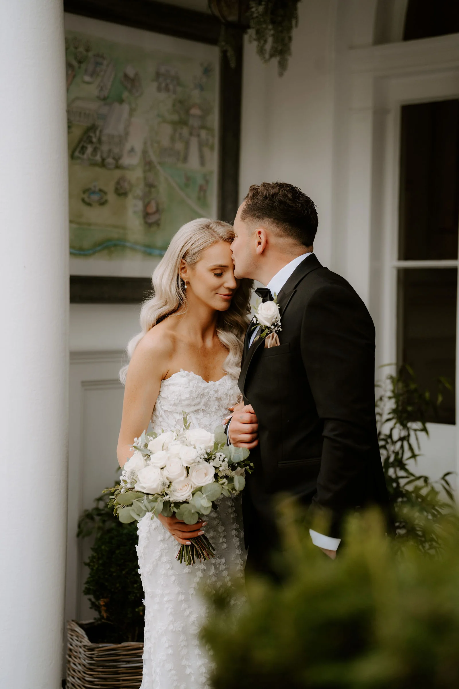 Sean kissing Bethany's forehead on the terrace at Deer Park Country House