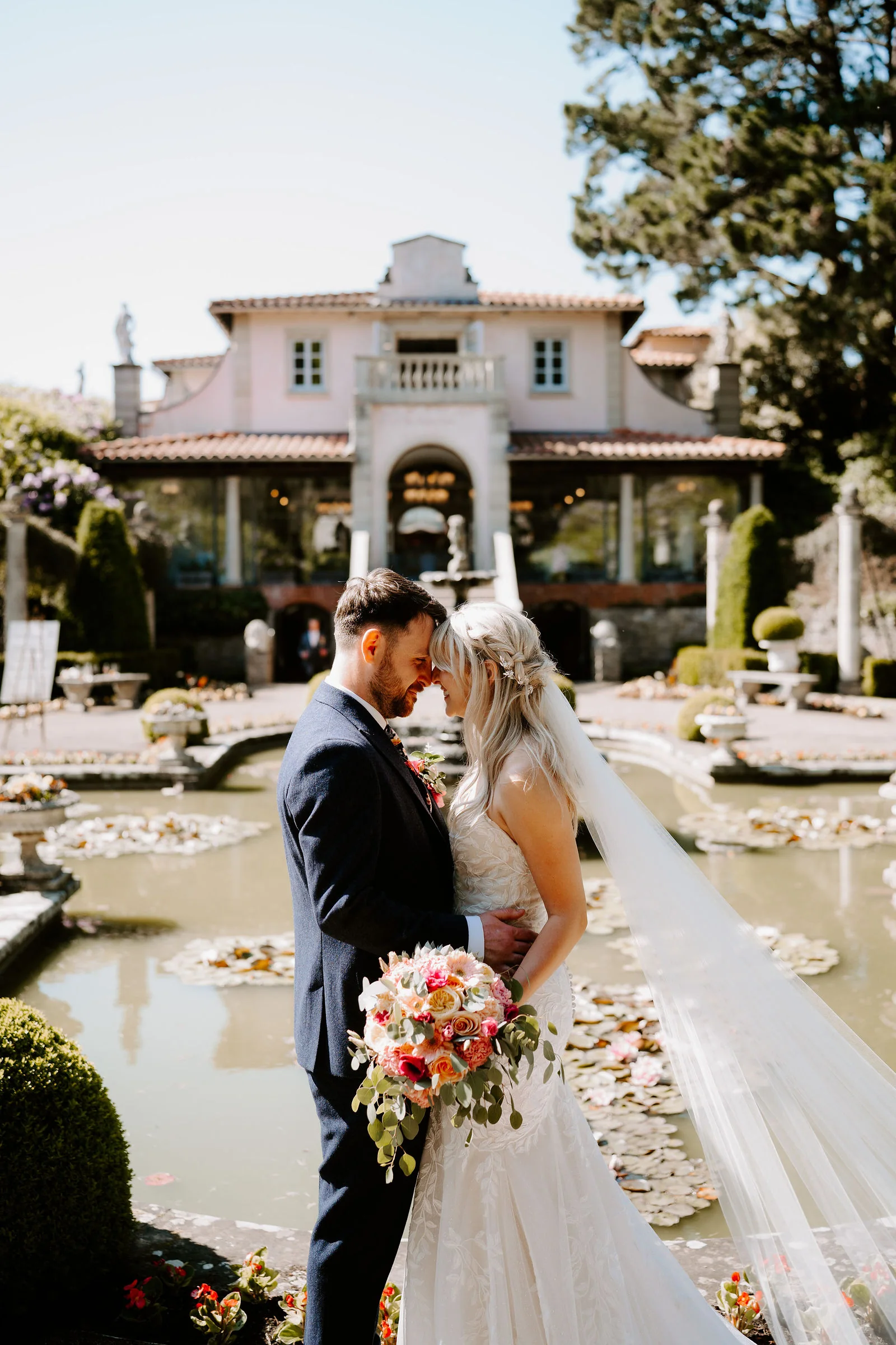 Erica and Pete in an intimate portrait beside the lily pond at The Italian Villa