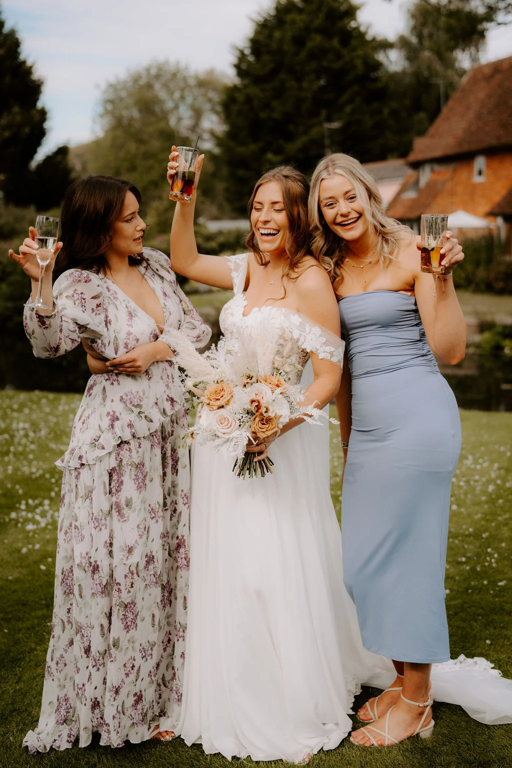Kim celebrating outdoors with two friends holding their drinks