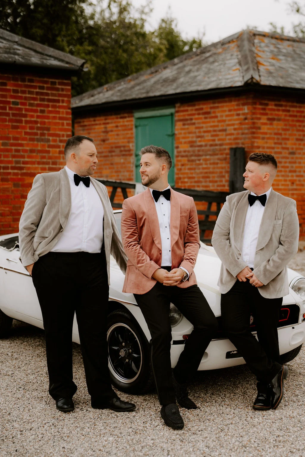 James with his wedding party beside a car before the ceremony