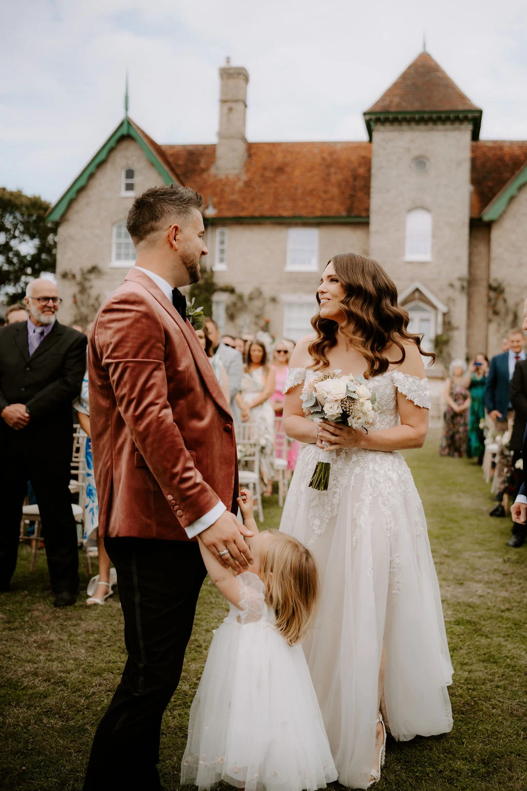 James and Laressa holding hands in the garden at Smeetham Hall Barn