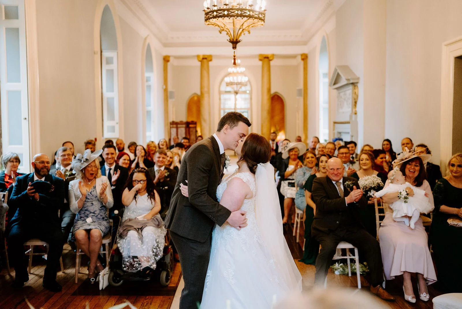 Zoe and Cory ceremony first kiss inside the Gothic ballroom at Clearwell Castle