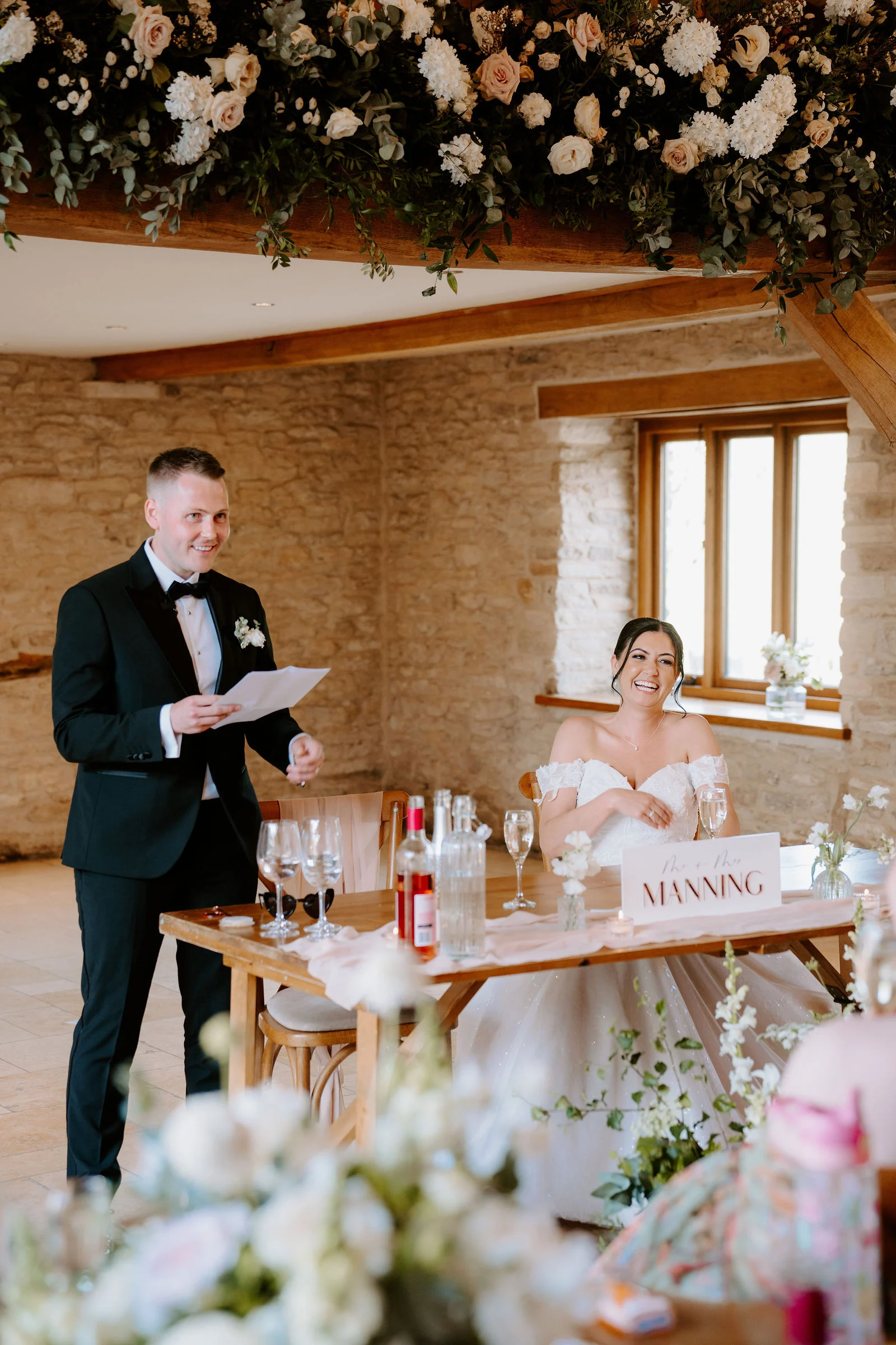 Natural smiles and laughter during couple portraits at Kingscote Barn