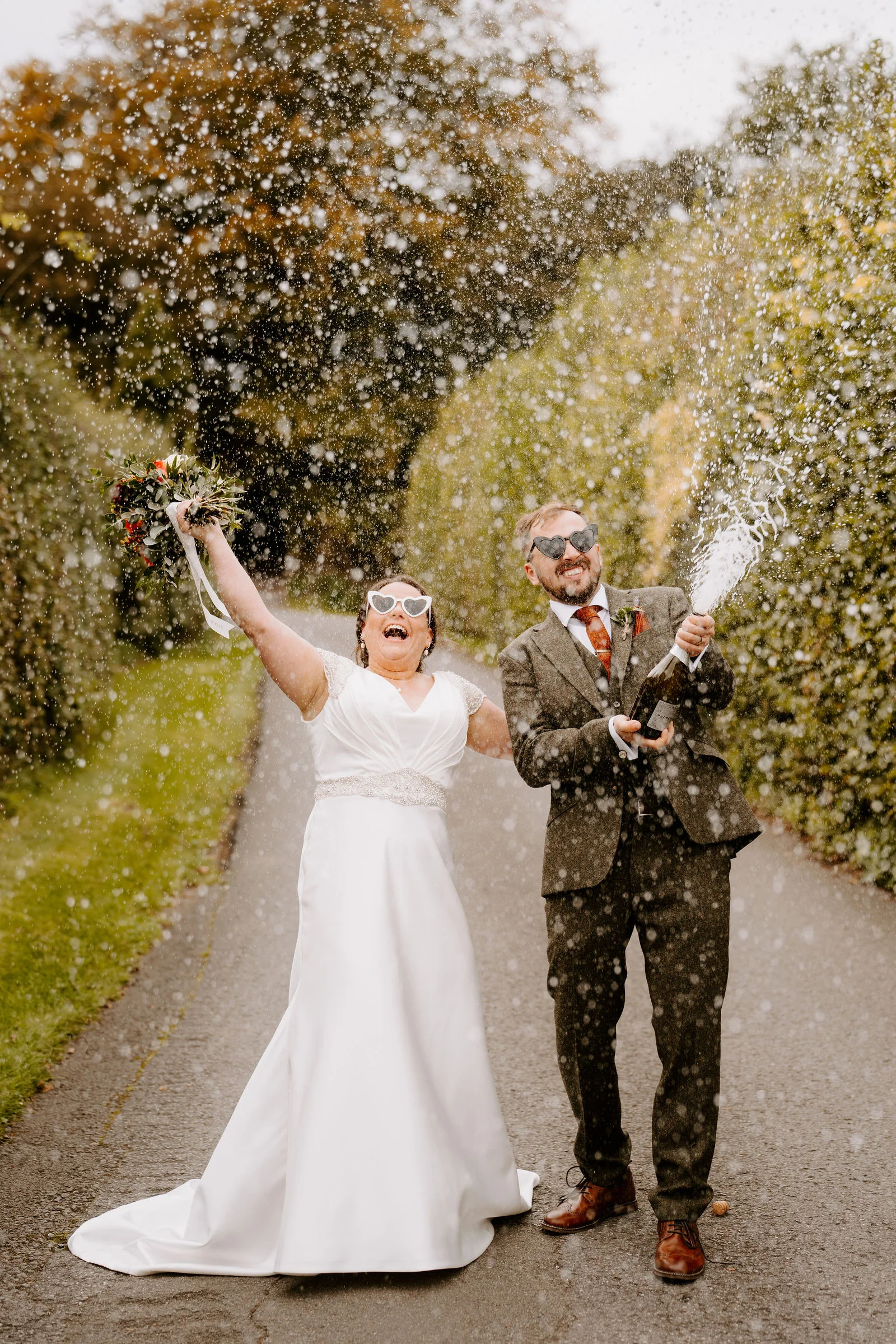 Zoe and Jack laughing together on the hillside meadow overlooking the secluded Kingscote valley