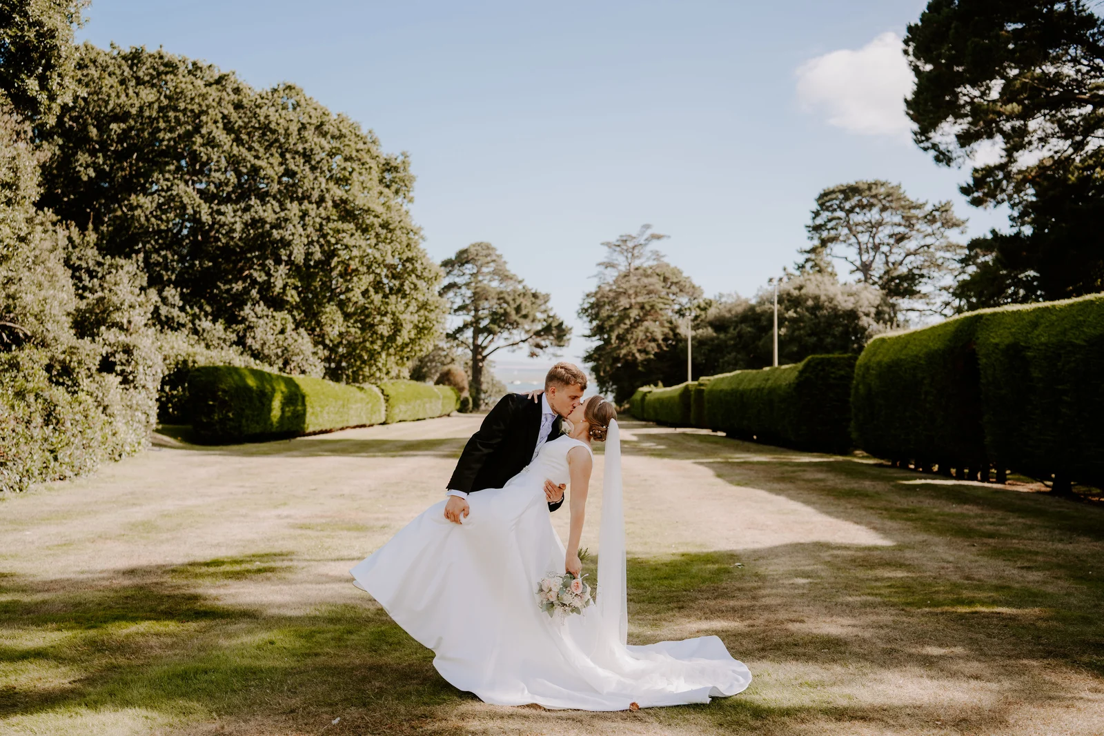 Chloe and Matt walking together through the gardens at Beaulieu in the New Forest