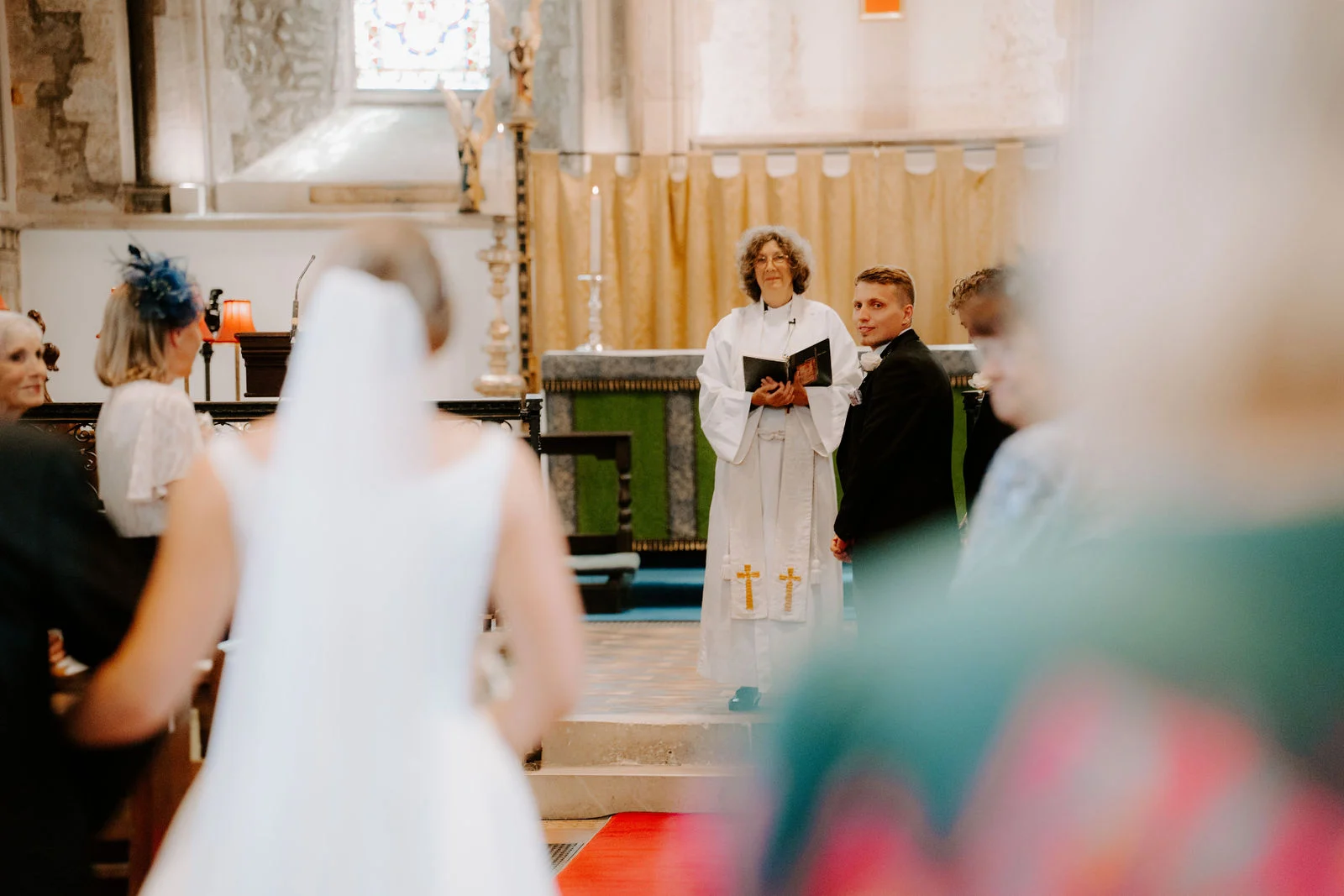 Chloe and Matt standing together during their ceremony in Beaulieu Abbey Church