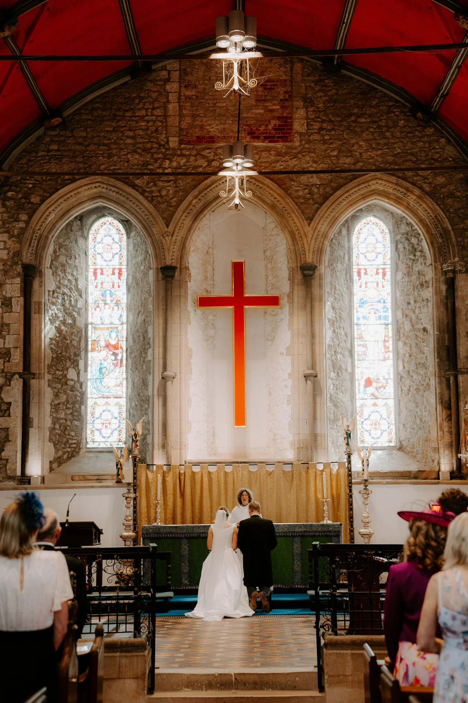 Wide view down the aisle of Beaulieu Abbey Church during Chloe and Matt’s wedding