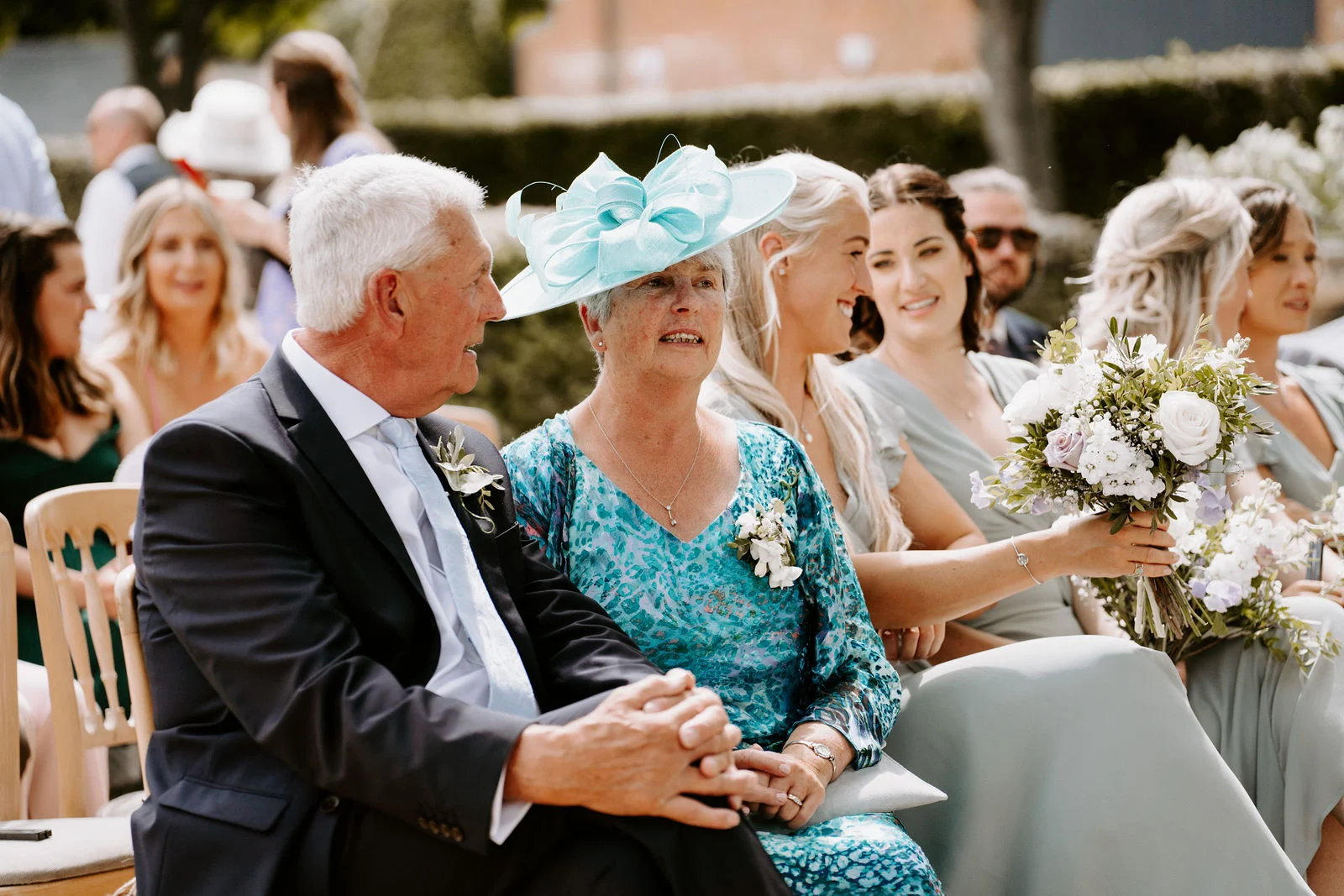 Family guests smiling together during Tom and Sarah’s outdoor ceremony at Bury Court