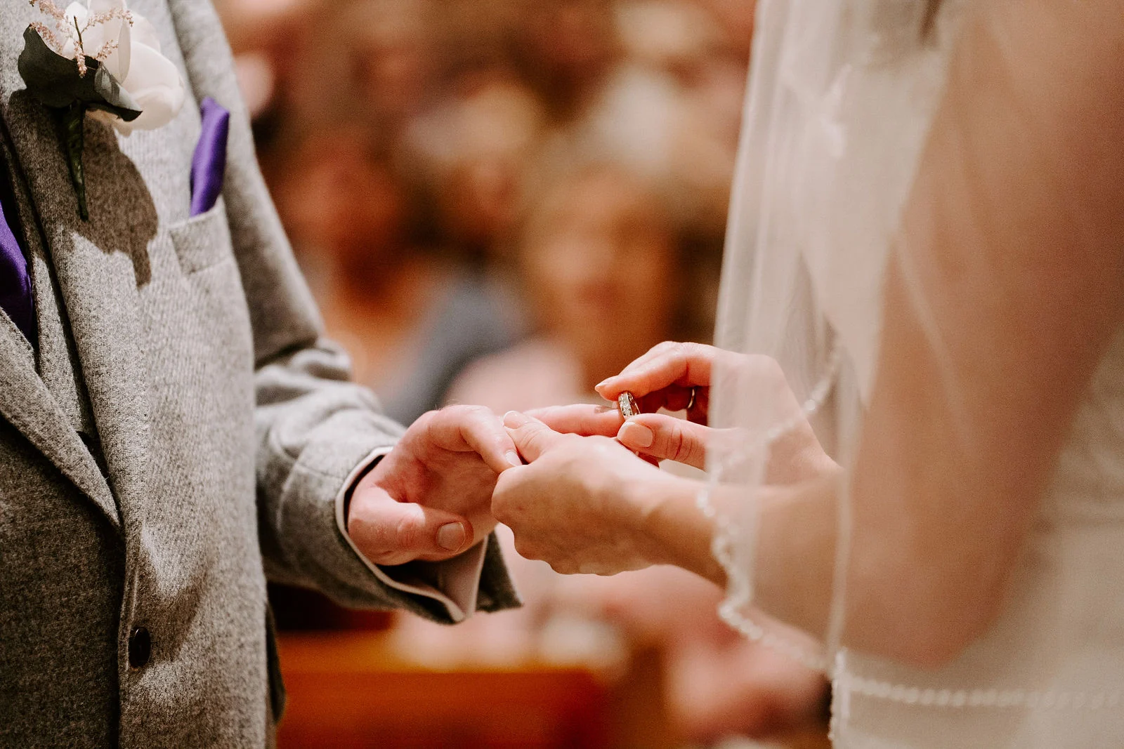 Stuart placing a ring on Laura’s hand during their Old Thorns wedding ceremony