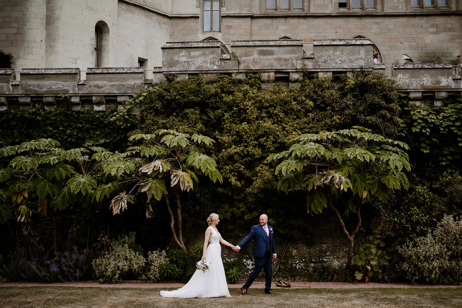 Kristina & James golden hour couple portrait on the upper terrace ramparts at Eastnor Castle in Herefordshire