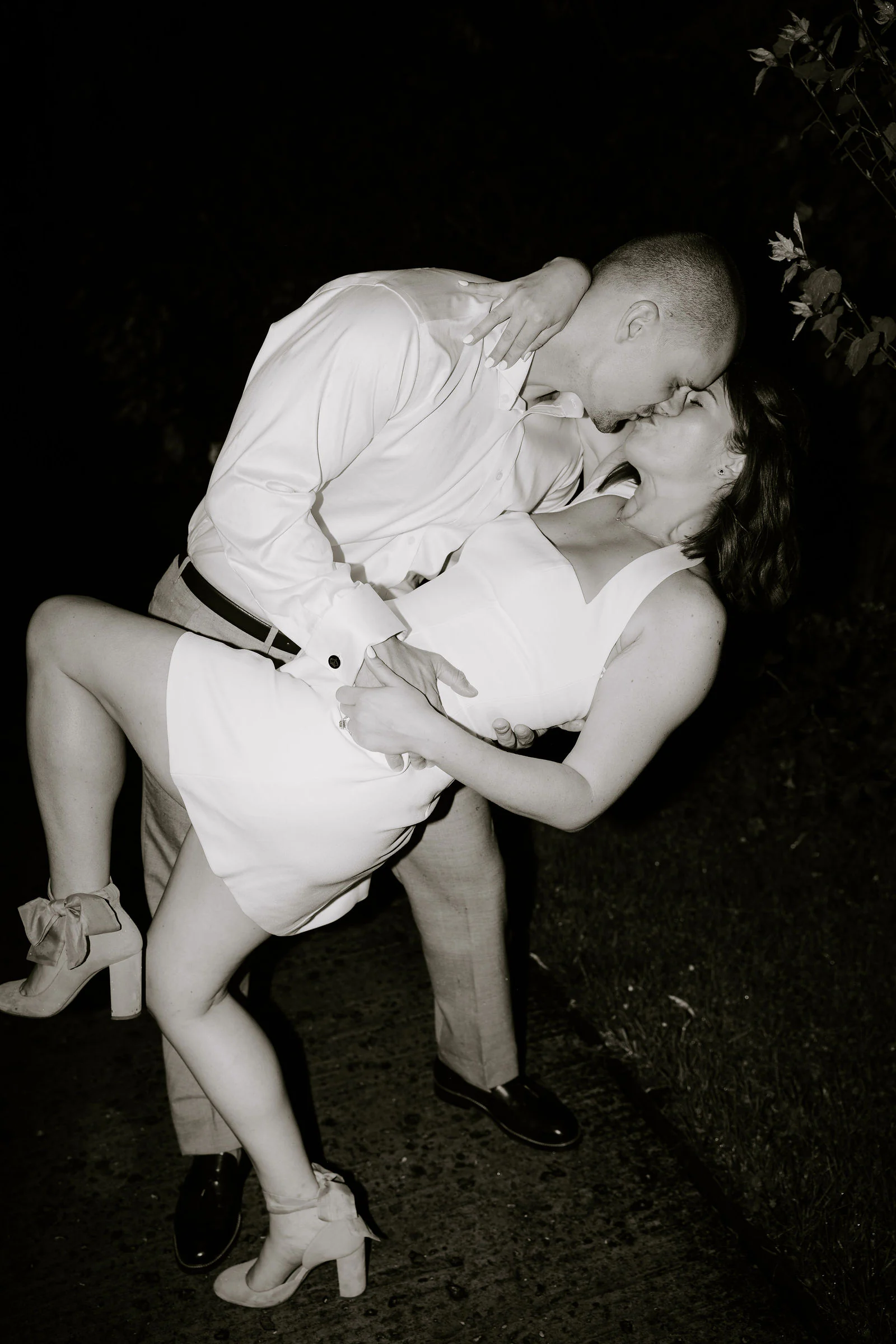 A bride and groom kiss in a dramatic dip on the dance floor at night at Hayne House near Hythe