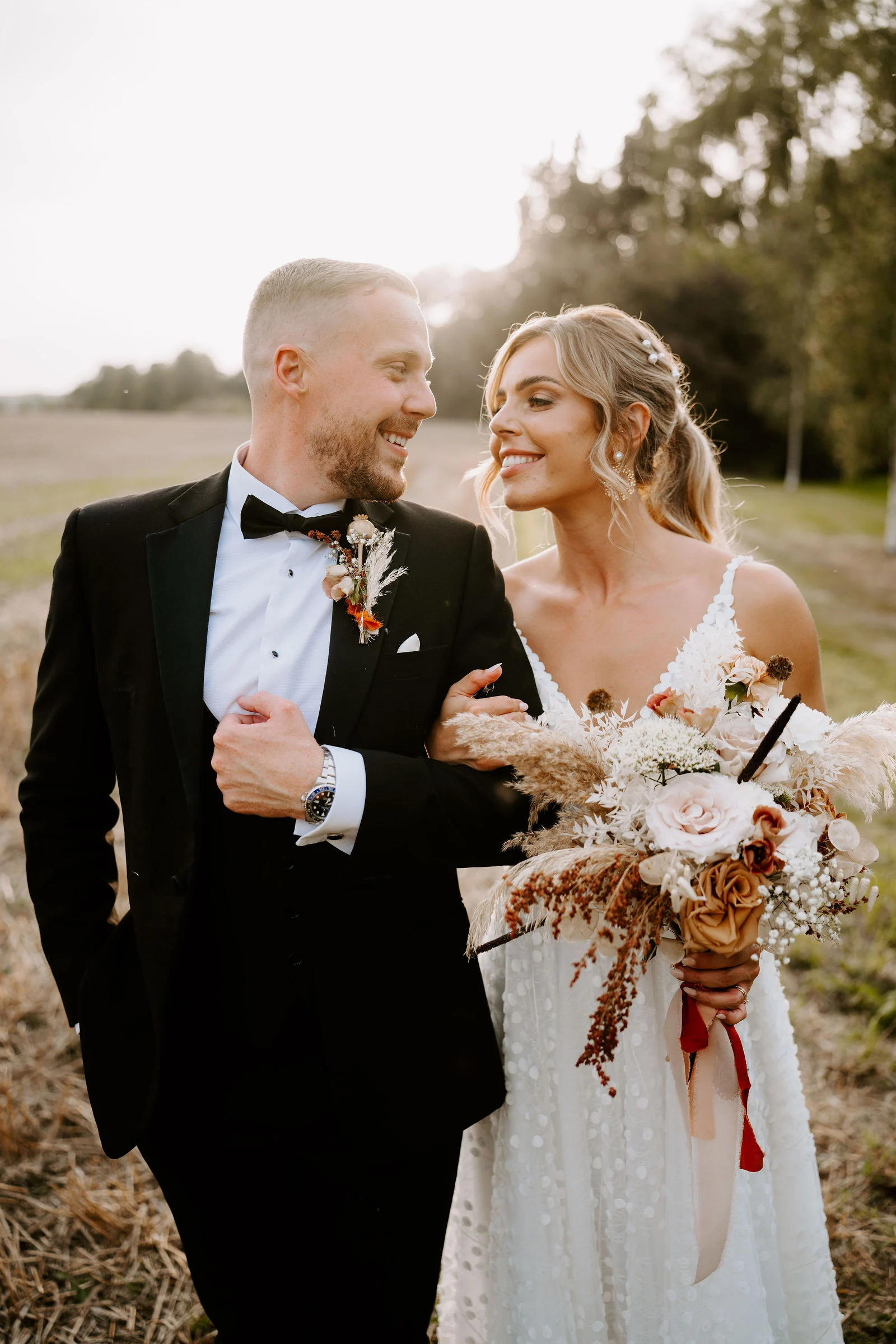 Emma and Tom smiling at each other during a portrait walk