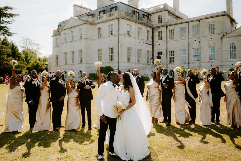 Sapphire dancing outdoors with guests in front of Addington Palace.
