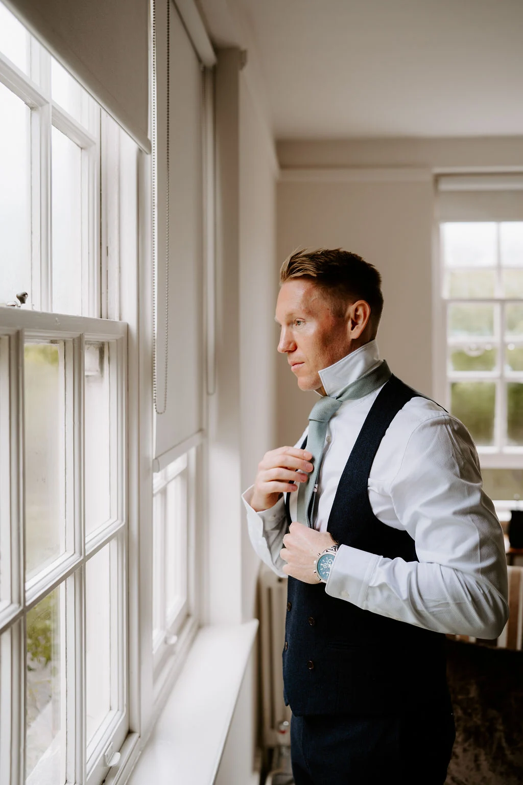 Russel during preparations beside a window.