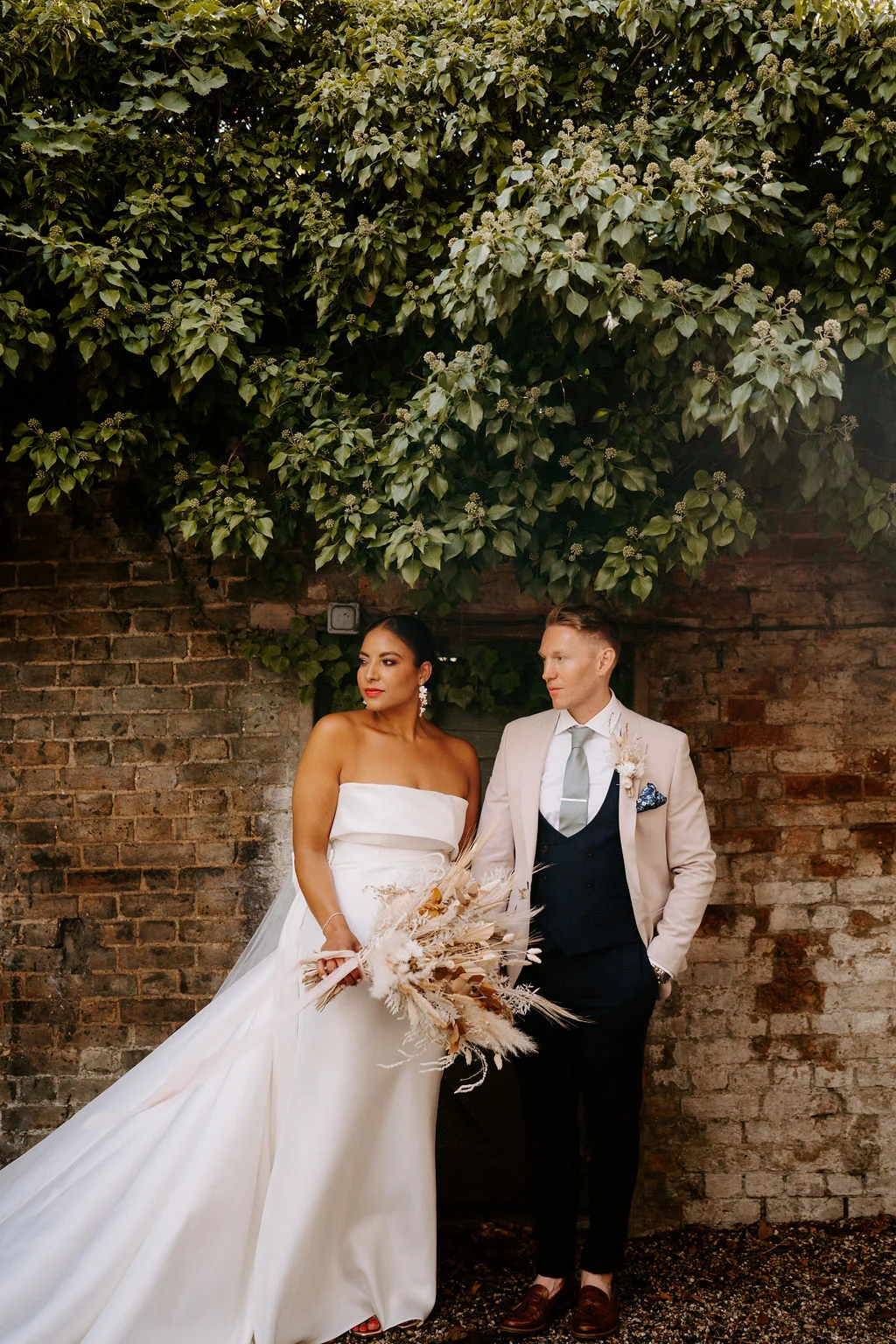 Shanice and Russel together beneath an arch of trees.