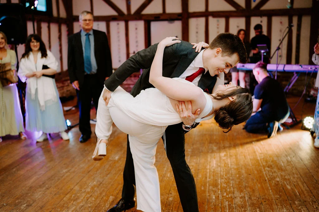 Katherine and Ryan dancing together with guests around them.