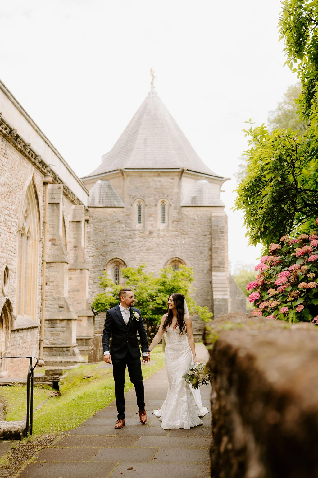 Carla and Callum walking together outside a historic building.