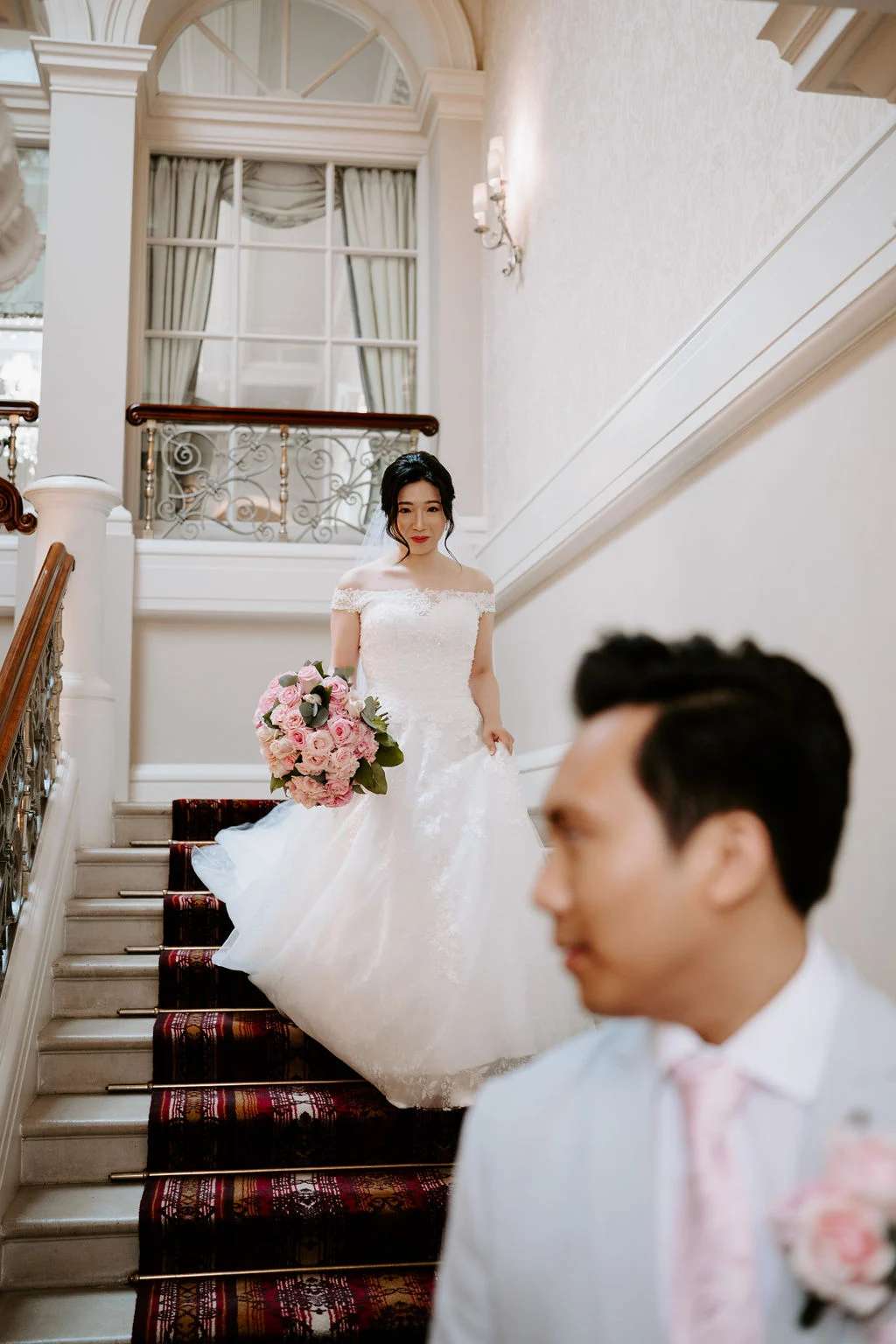 Stephanie on the staircase with Leonard waiting below.