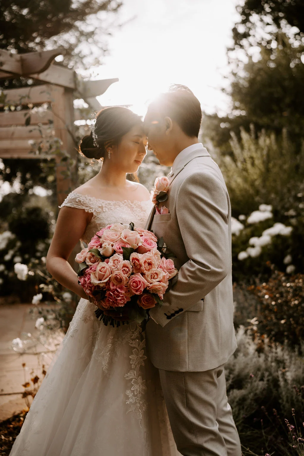 Leonard and Stephanie embracing with flowers around them.