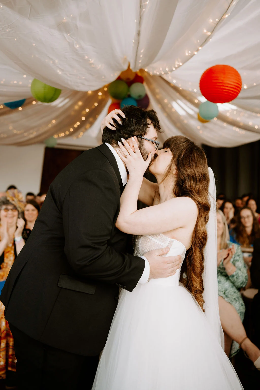 Josie and Nick dancing beneath colourful streamers.