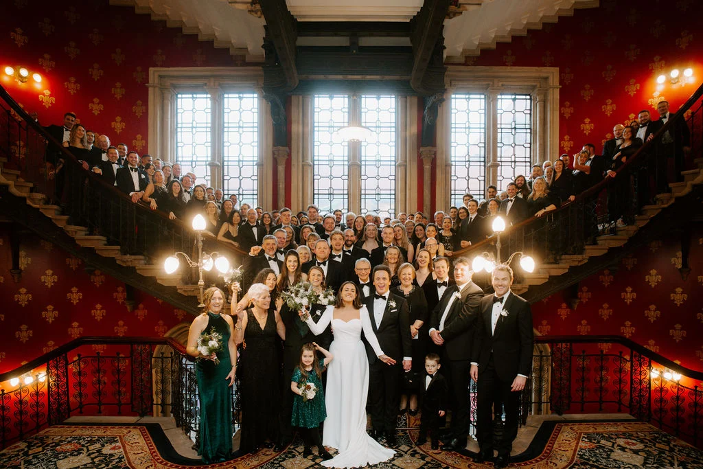 Jo and Sam with their guests gathered on the staircase.