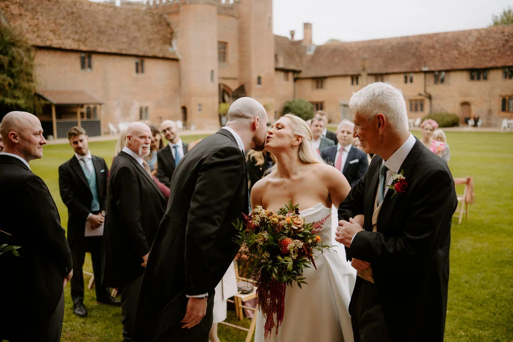 Sophie and Jake with guests in the courtyard.