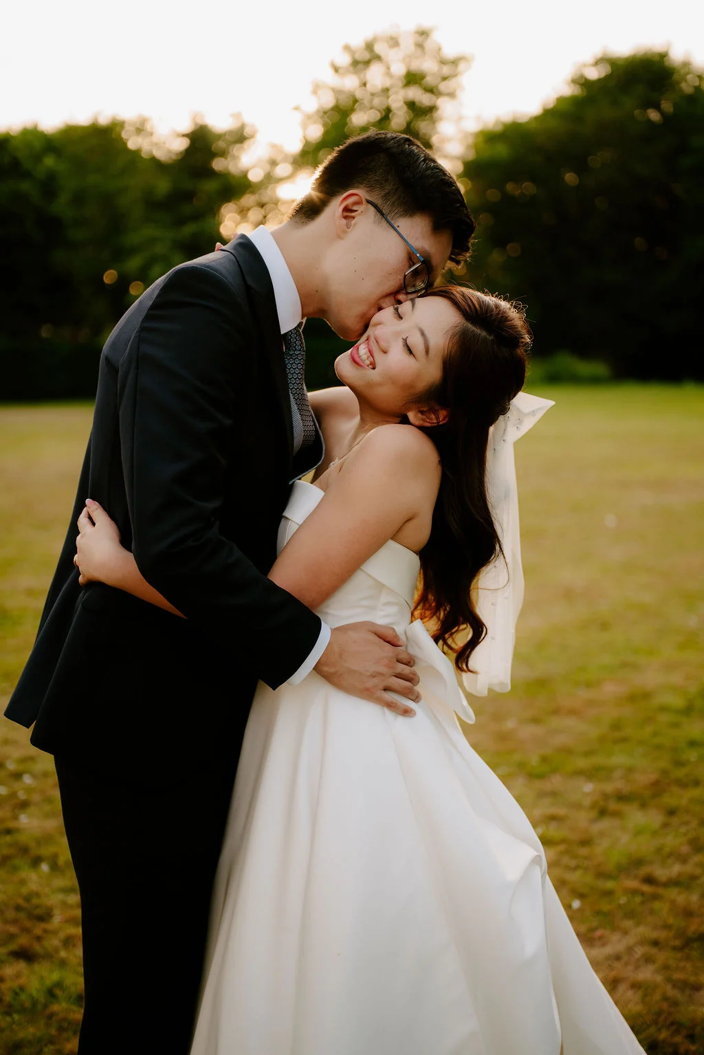 Jonathan and Tasha sharing a kiss in the gardens.