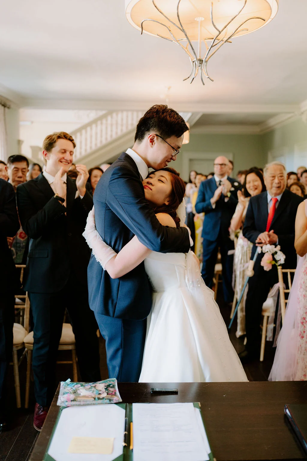 Jonathan and Tasha sharing a kiss in front of their guests.