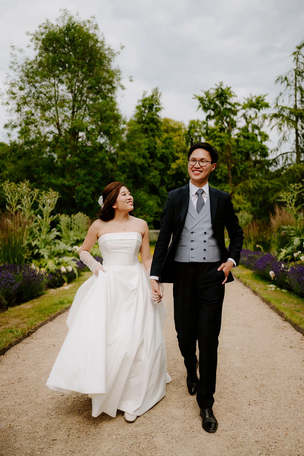 Jonathan and Tasha walking together along a garden path.
