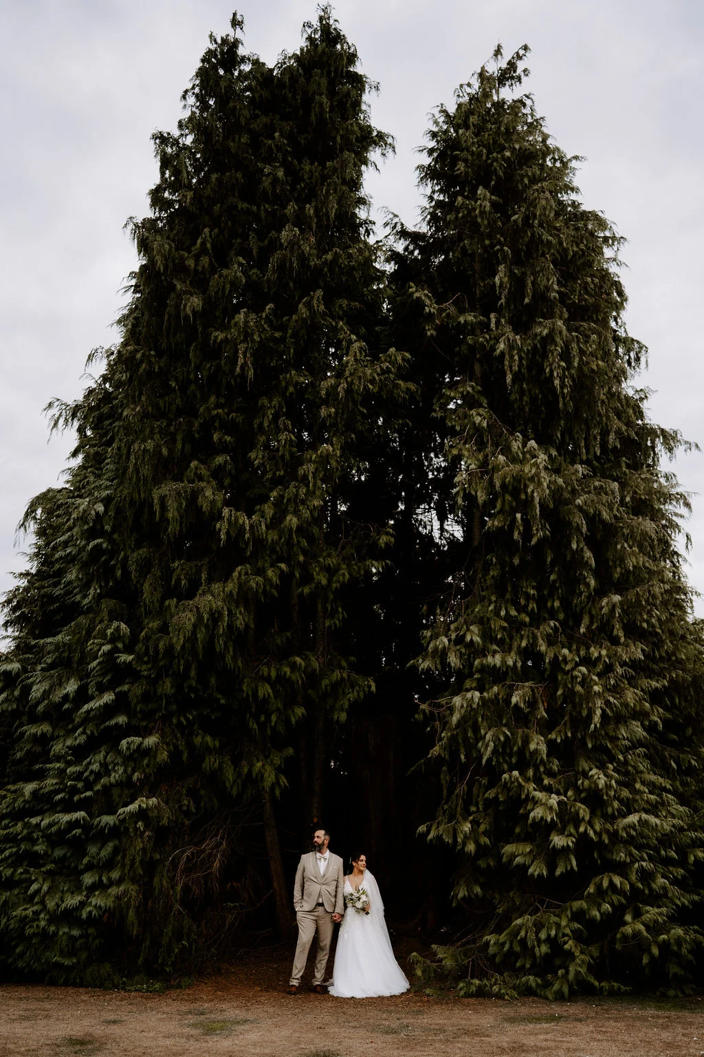 Hugo and Mel beneath a tall tree in the grounds.