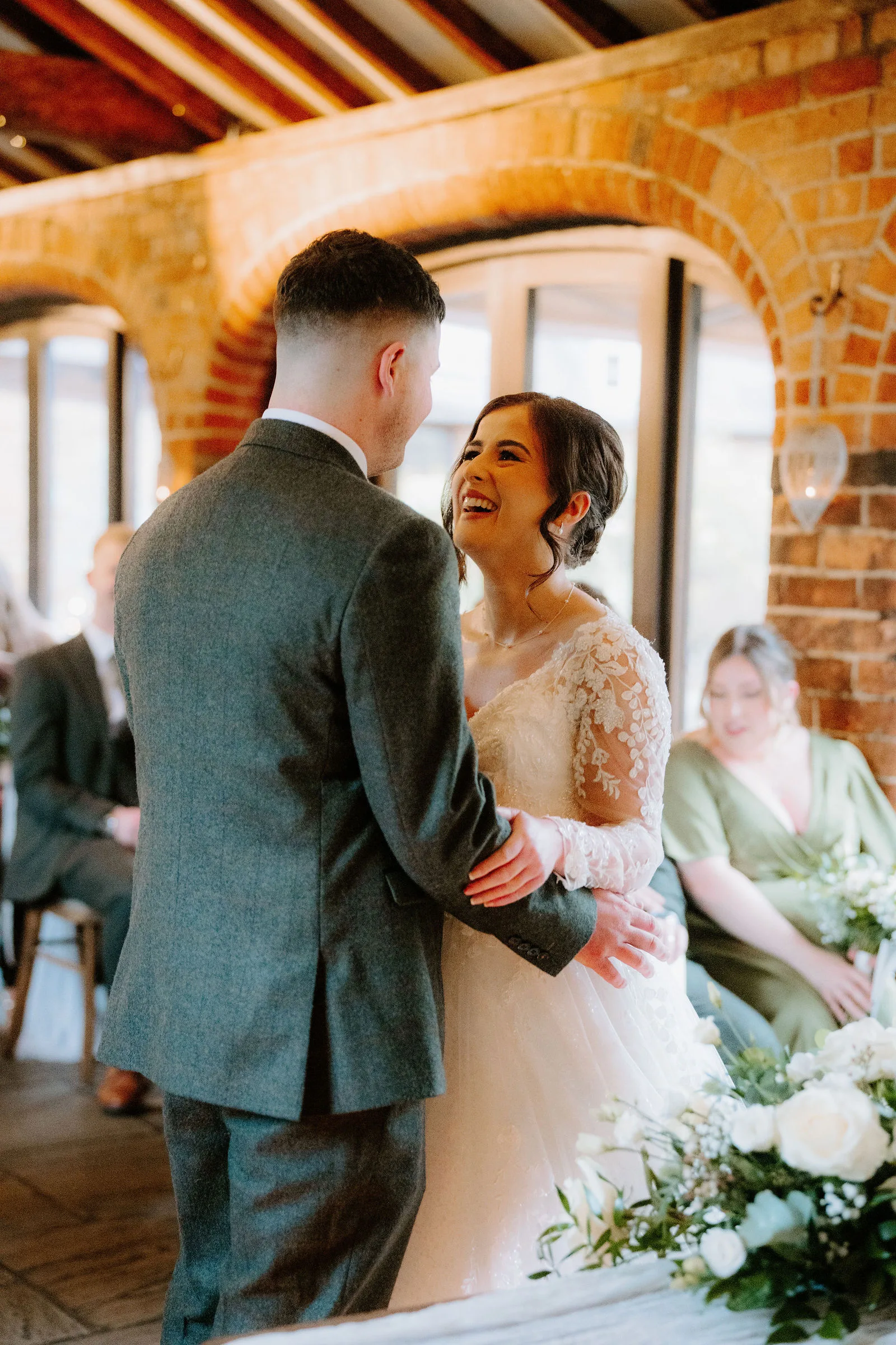 Charlotte and Jack holding each other during their barn ceremony